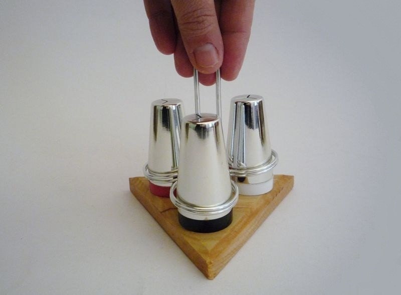 Three Vintage Salt Shakers in a Display
