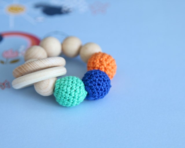 Teething toy with crochet wooden beads and 2 wooden rings. Blue, orange, green wooden beads rattle.