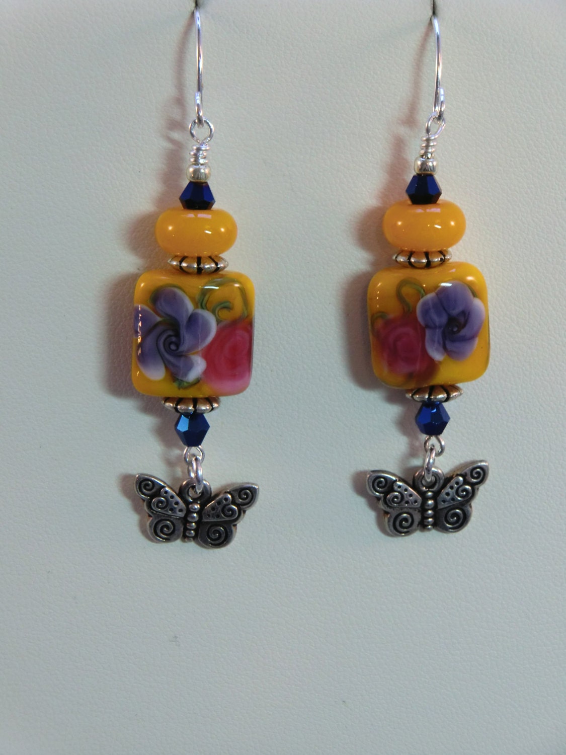 Golden yellow, pink and blue lampwork pillow bead flower earrings, butterfly dangle earrings in silver, yellow, and pink