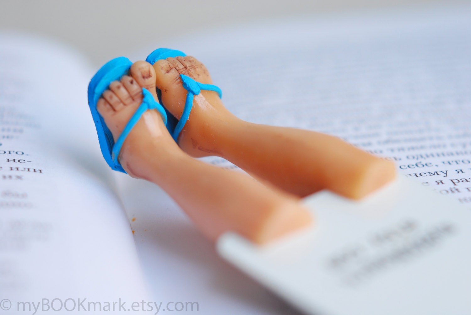 Summer bookmark. Legs in blue summer flip-flops. Aqua blue for him. Nautical for vacation by the sea . Beach reading