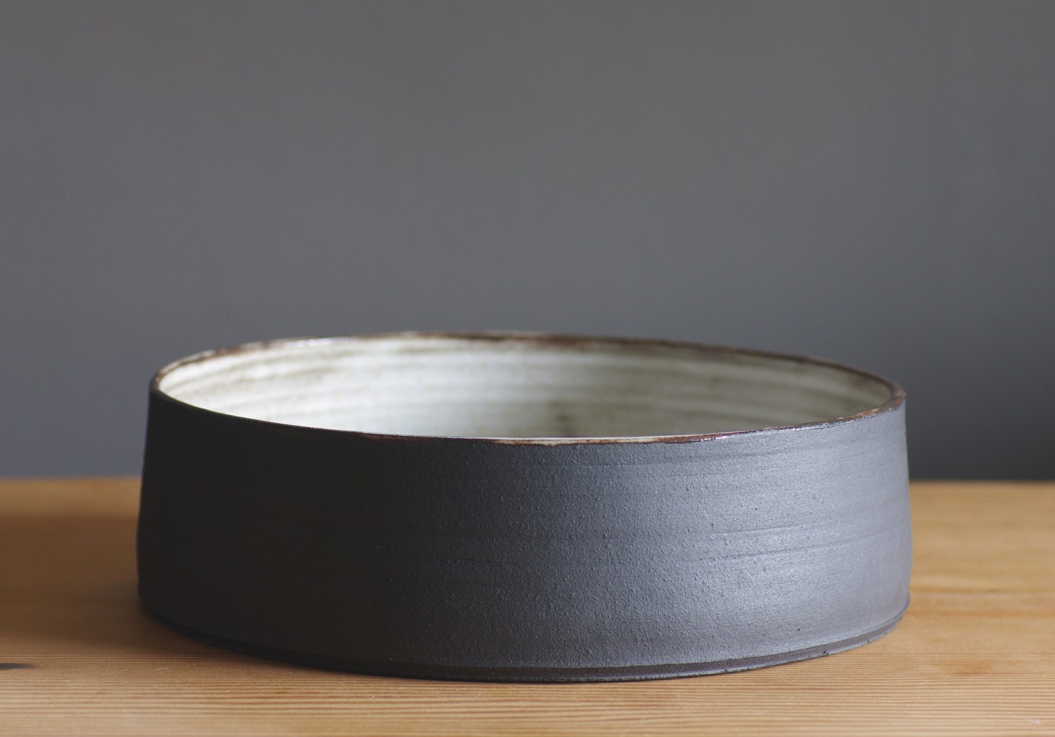 extra large bowl. fruit bowl made of black clay with white glaze, modern pottery minimal ceramic