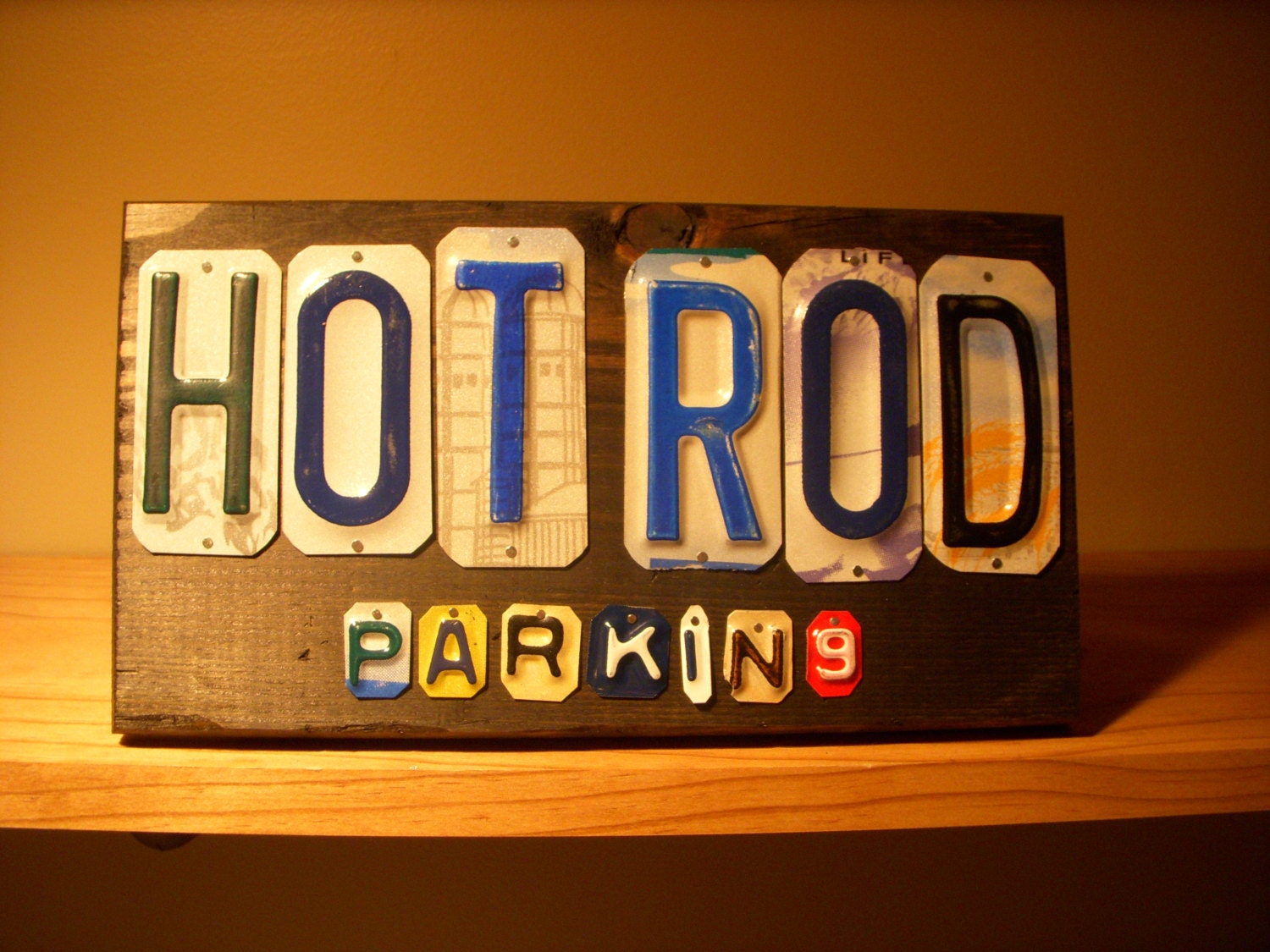 Hot Rod parking sign made with recycled license plates.