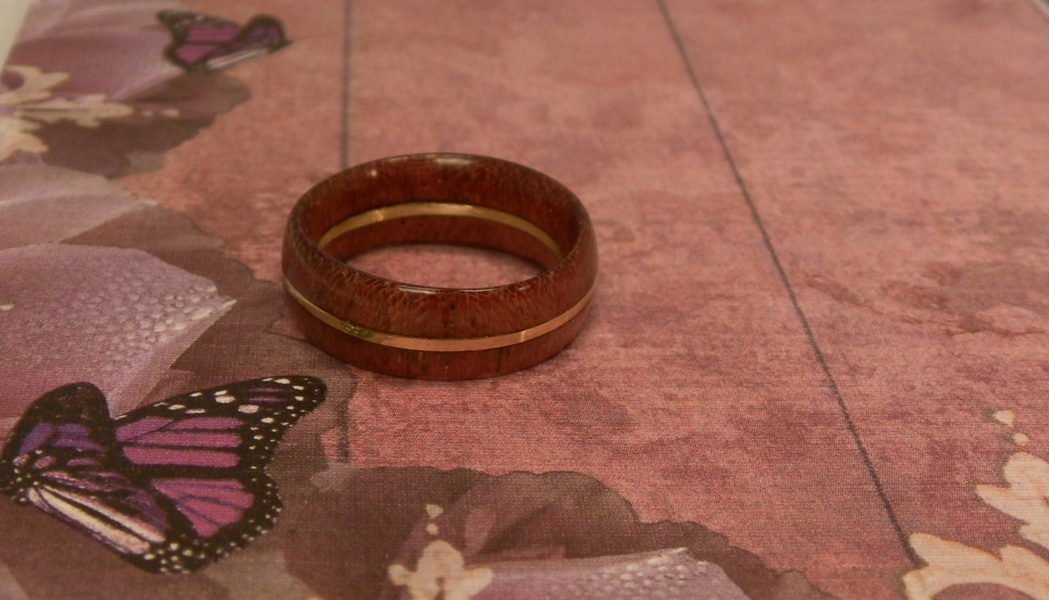 size 6 1/4 ring made from Purpleheart wood with a band of brass in the middle