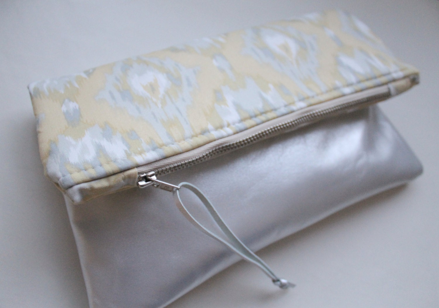 Fold over clutch, yellow and gray ikat print, silver leather