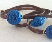 Cinnabar Wrap Bracelet: Triple Wrap in Brown Leather with 3 Cyan Blue Carved Beads