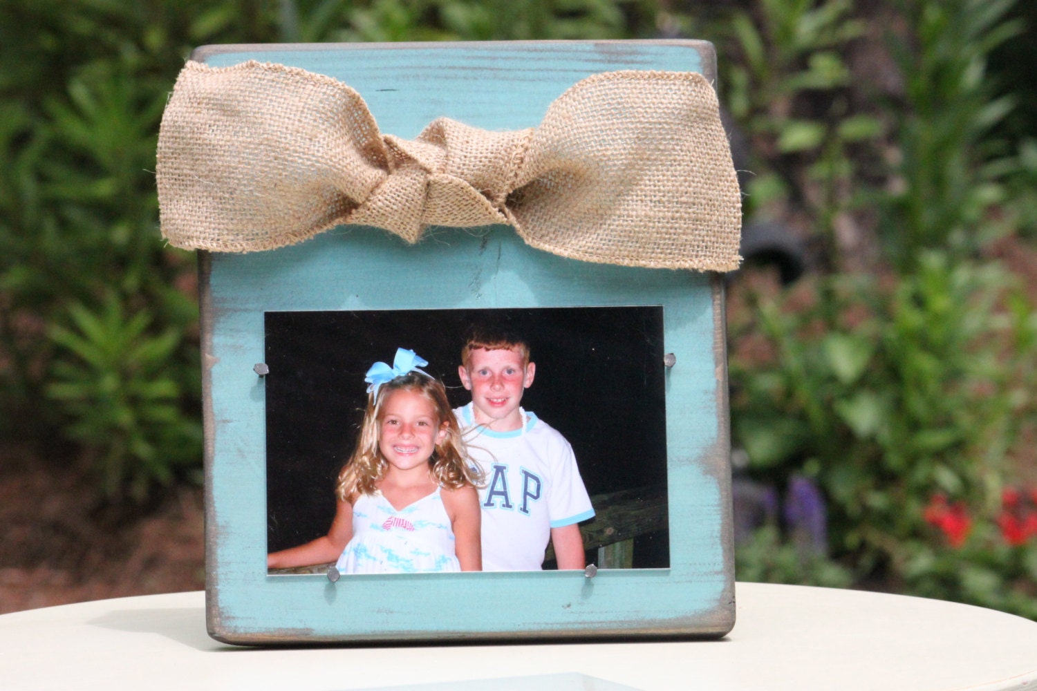 Blue Distressed Wooden Frame with a Natural Burlap Bow