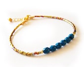 Friendship Bracelet with Faceted Blue Beads and Dark Gold Delica Glass Beads - DicopeJewelry