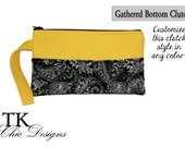 UCF inspired gameday gathered bottom clutch with a black & white paisley print and solid gold
