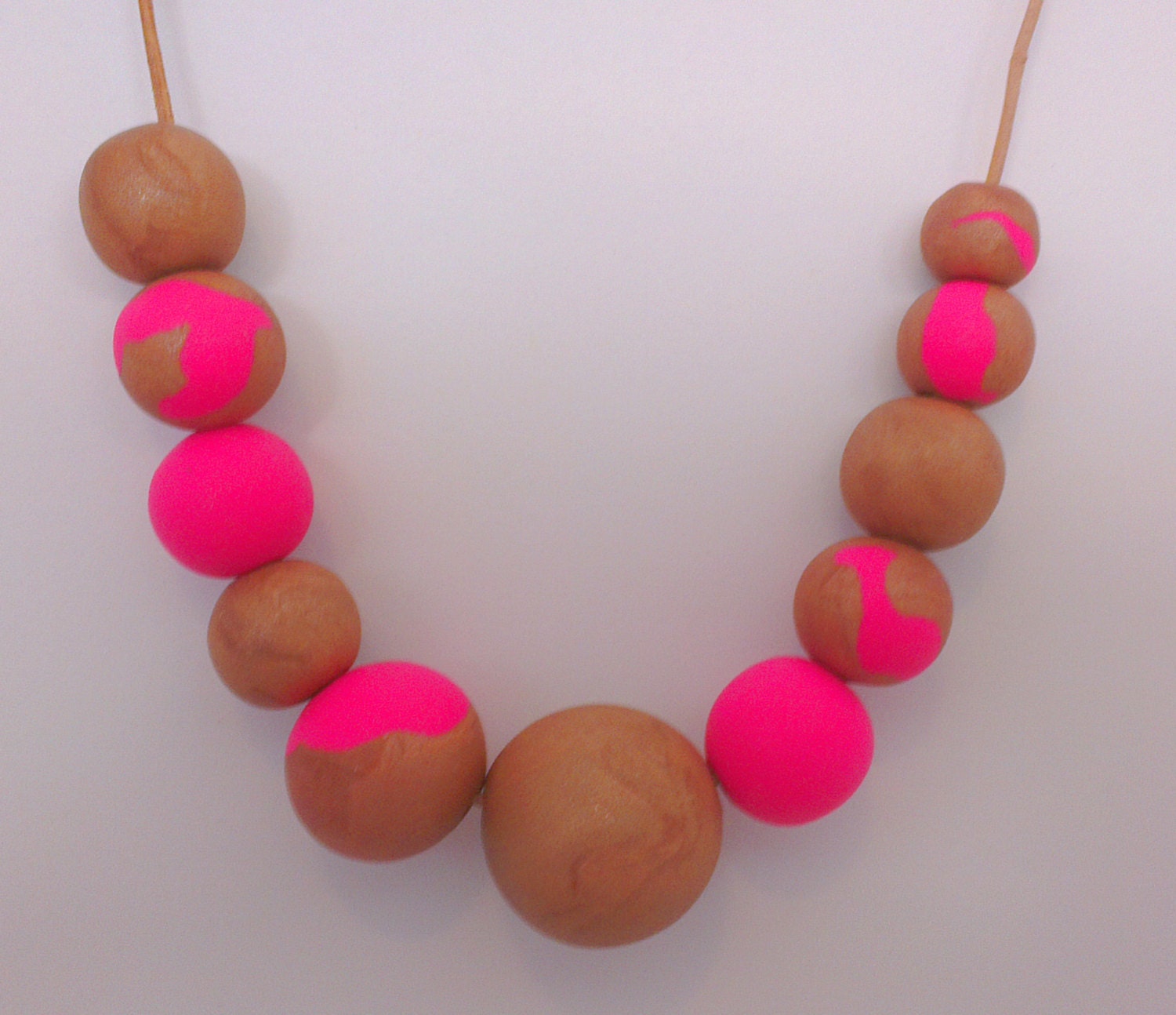 Duo toned rose gold and neon pink handmade polymer clay beaded necklace on leather.
