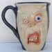 Horned Zombie Face Mug with bloodshot eyes black glaze