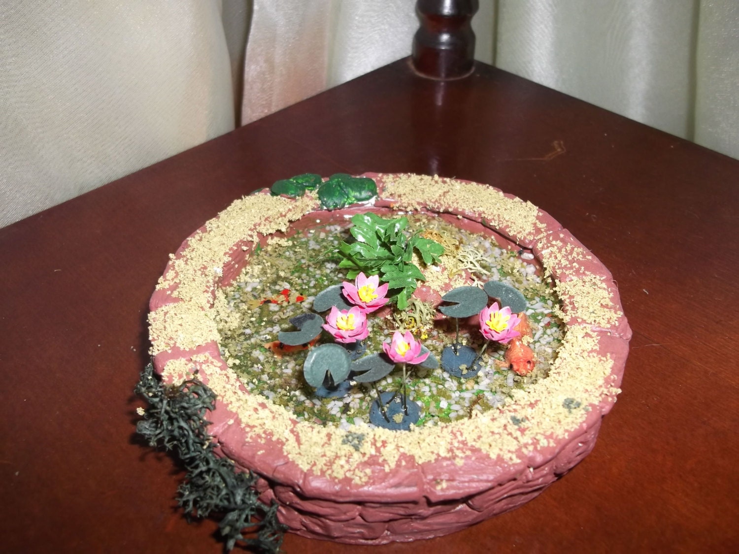 Round pond with water lillies and gold fish
