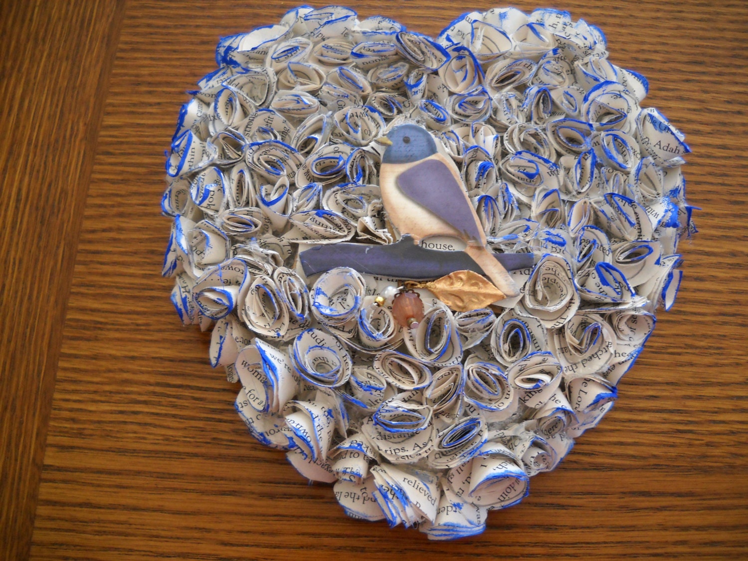 Decorative Heart Shape Rose Wreath With Bluebird in center, tips of pages painted blue, measures 7X7