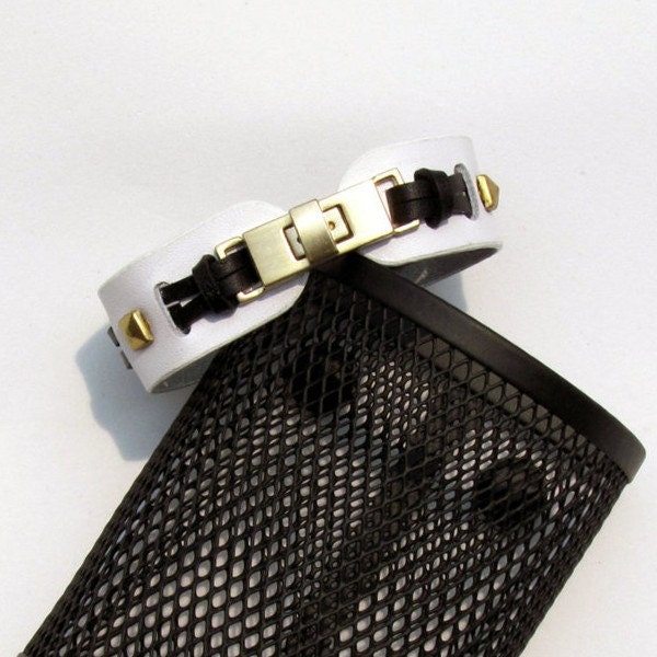 Modern style, White Leather Cuff Bracelet is laced with black leather strips and pyramid studs for Women