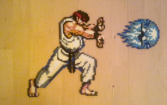 Ryu from the SNES-game Street Fighter 2 in HADOUKEN-pose, 16-bit bead sprite