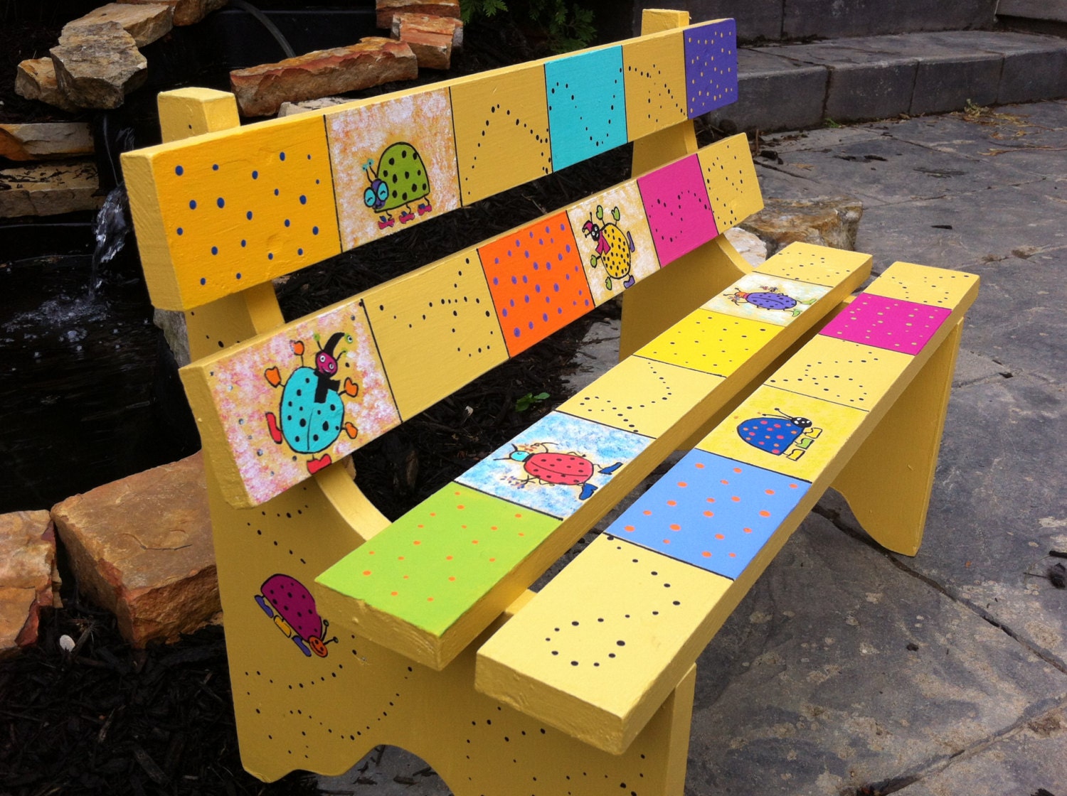 Colorful hand painted kids’ park bench with by LetThemBeKids