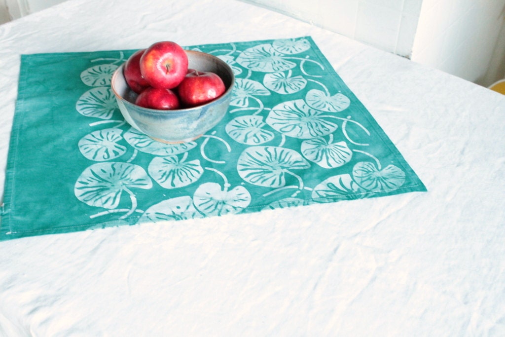 turquoise lilypad tea towel with a tab hand printed, hand dyed fabric