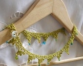 Olive green crochet necklace with beaded lace wing motif
