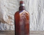 antique c. 1930s Mountain Man whiskey flask // amber glass bottle