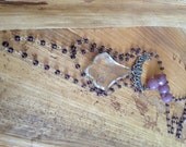 Purple beaded rosary necklace with a large crystal and silver finding