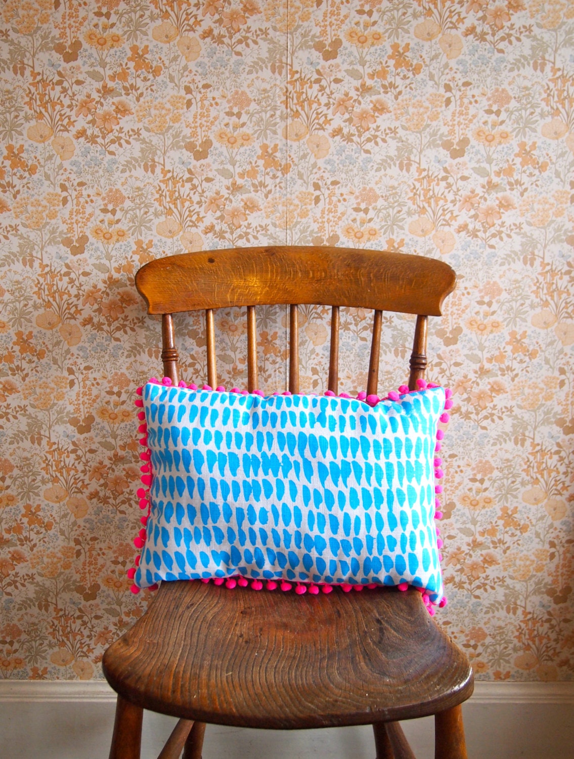 Neon Pink Pom Pom Cushion in Blue