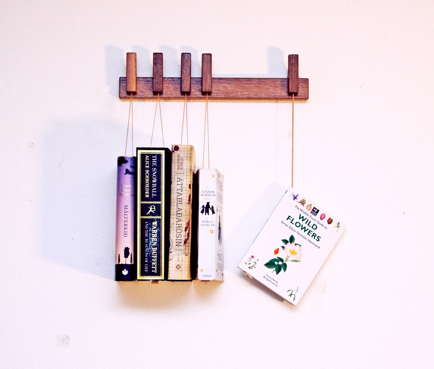 Custom made wooden book rack in Walnut. Pins also work as bookmarks. Bookshelf. Bookcase
