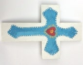 Painted metal cross on wood