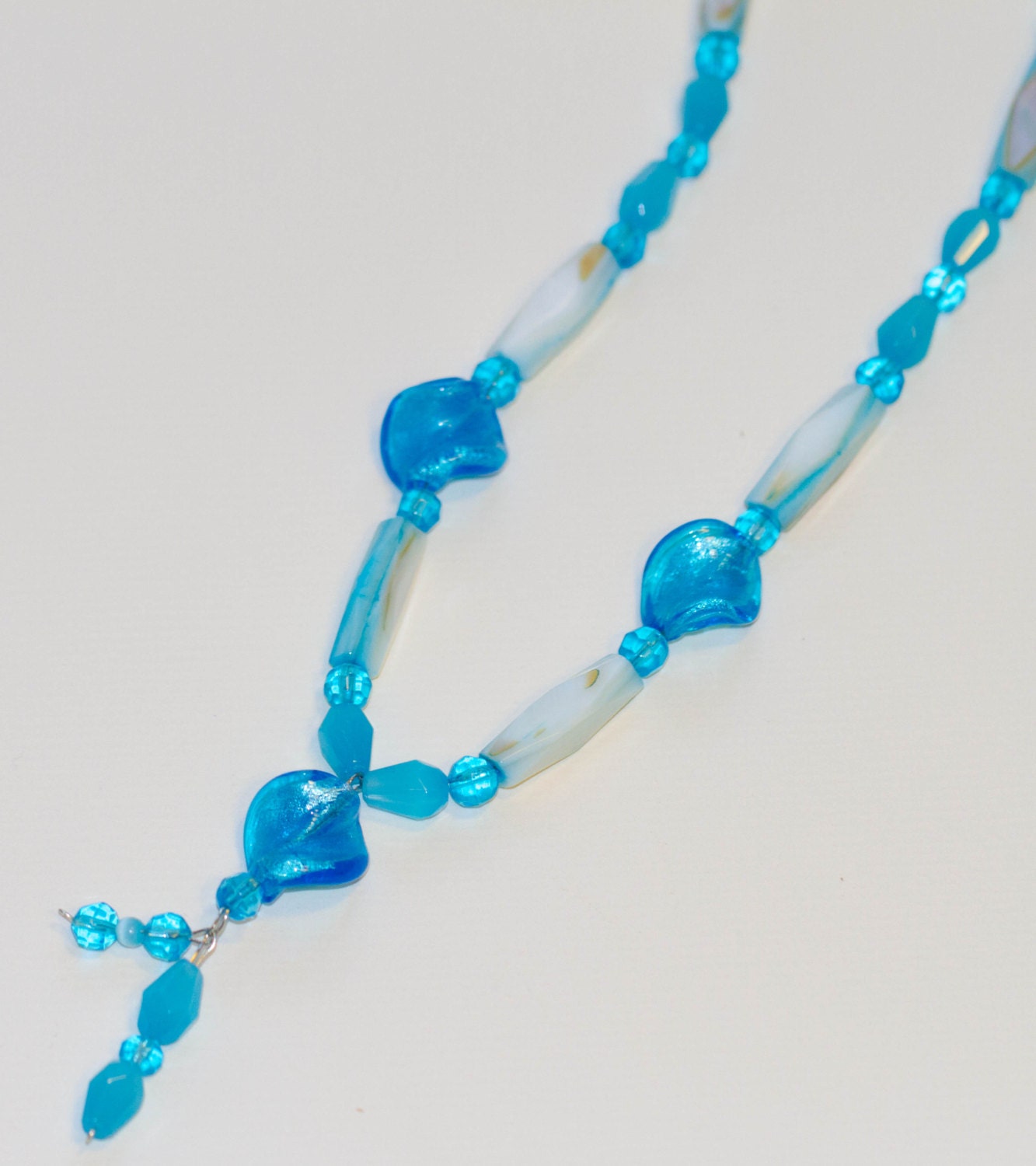 Bluedrop: Lampwork, shell and glass with a dangly beaded pendant.