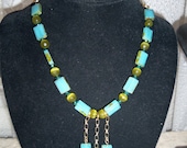 aqua glass beads with jade high lights and jade glass beads with gold colored chain. Length 18   inches. Matching earrings