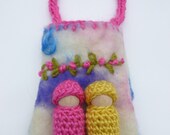 Two peg dolls in a felted wool pouch