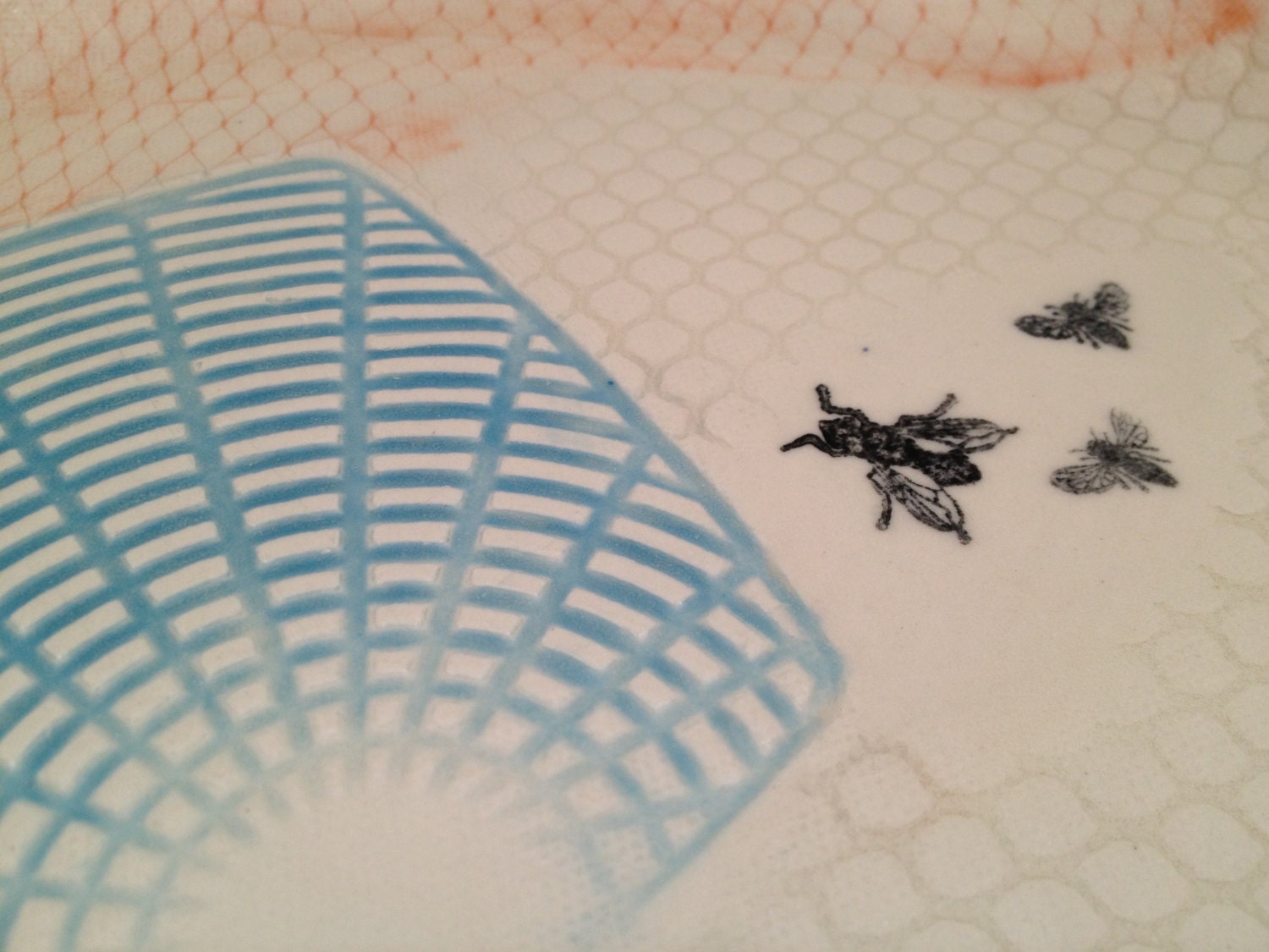 Orange and blue fly swatter plate