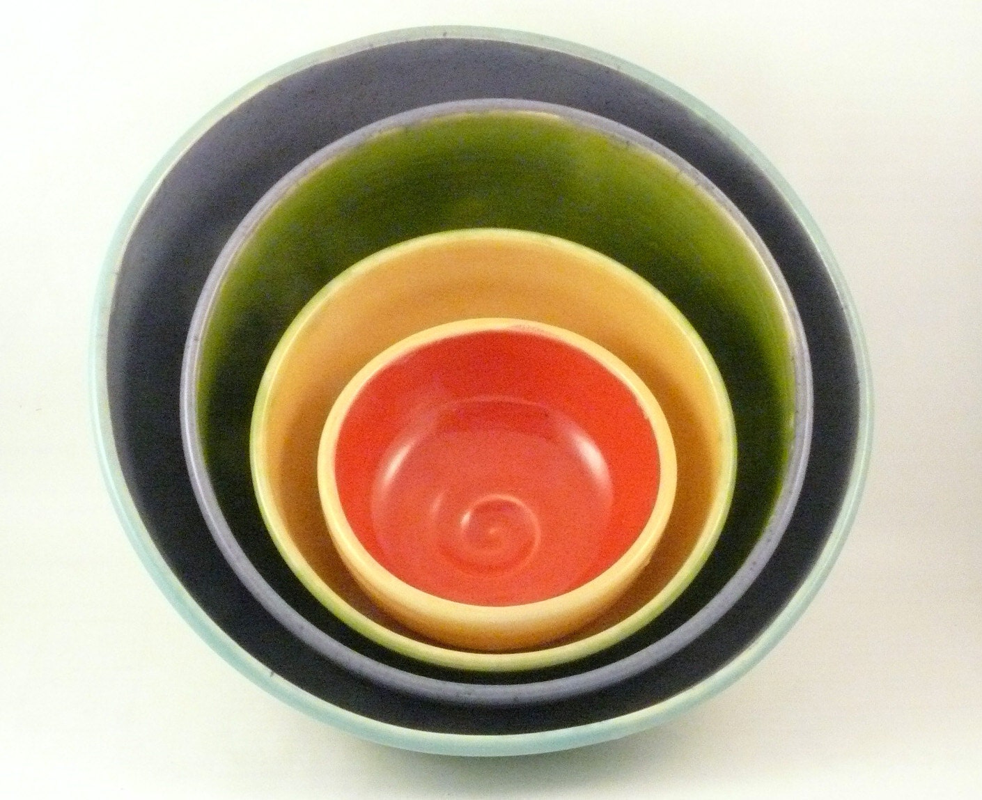 Set of four nesting bowls in red yellow green purple and blue