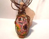 Wire wrapped Summer colored floral pendant on ribbon.