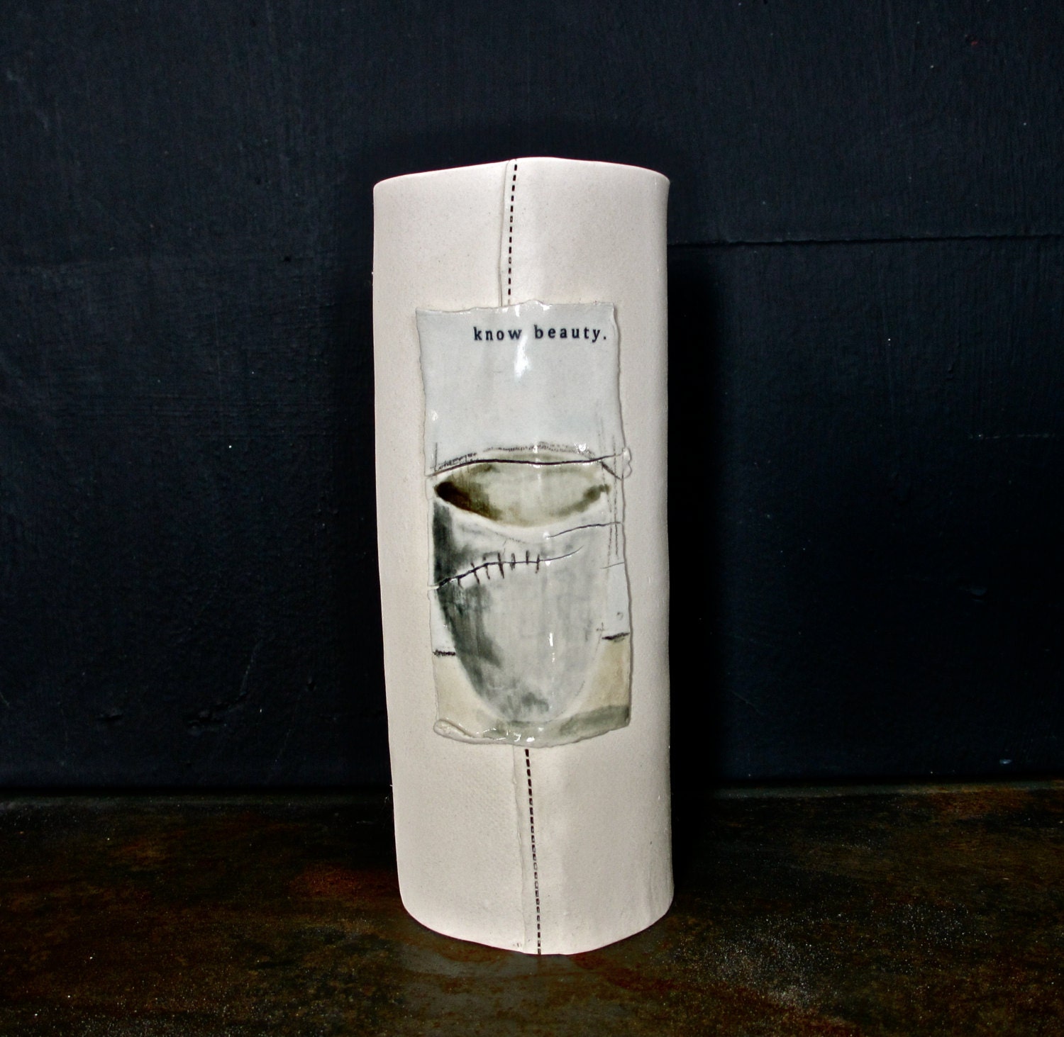 KNOW BEAUTY porcelain vase with a painting.