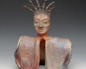 Buddha Statue With Spiked Hair Centered in a Shimmering Raku Ceramics Robe