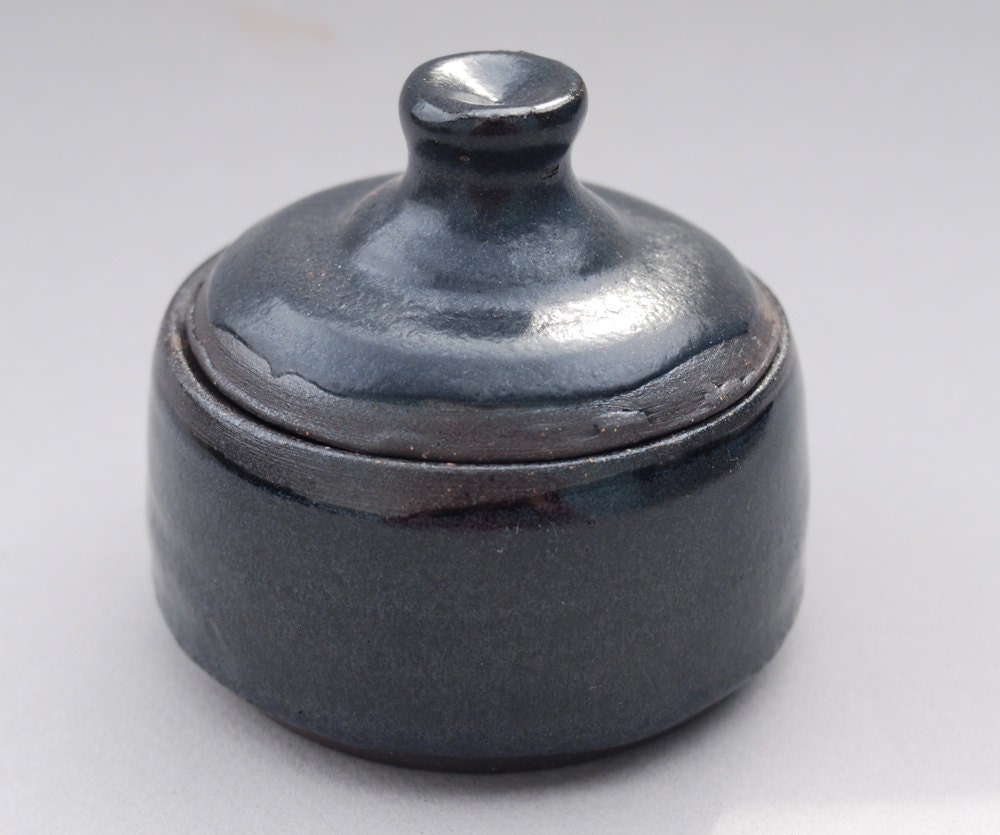 small lidded jar for sugar and spice and everything nice with a blue inside