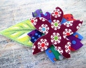 flower barrette - deep purple, green, and vibrant blues