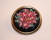 Handcrafted of polymer clay. Small brooch crafted in black, red and green colors.
