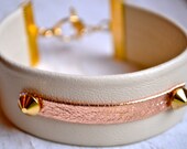 ivory lambskin leather with metallic rose gold leather ID tag and mini gold spikes bracelet