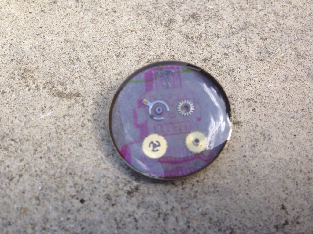 Pink robot with cogs badge