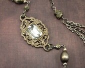 Multi-strand asymmetrical statements necklace with chunky vintage rhinestone accent, antique silver, steel and pyrite