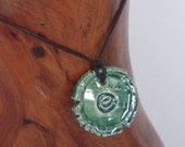 handmade ceramic rustic swirl pendant on leather cord