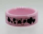 Valentine Ring with lots of random Laser Engraved Heart symbols on a Pink Ring