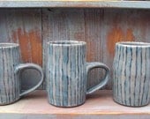 One wheel thrown stoneware mug with turquoise and teal stripes // by Lyn Carey of Earth and Wears
