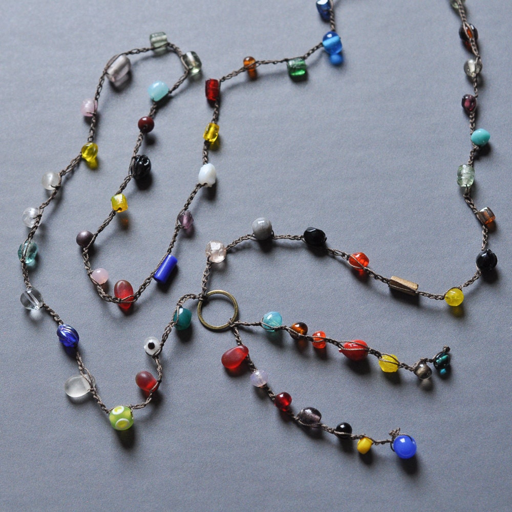 Long crocheted multicolor festival necklace with bronze circle charm and fringe