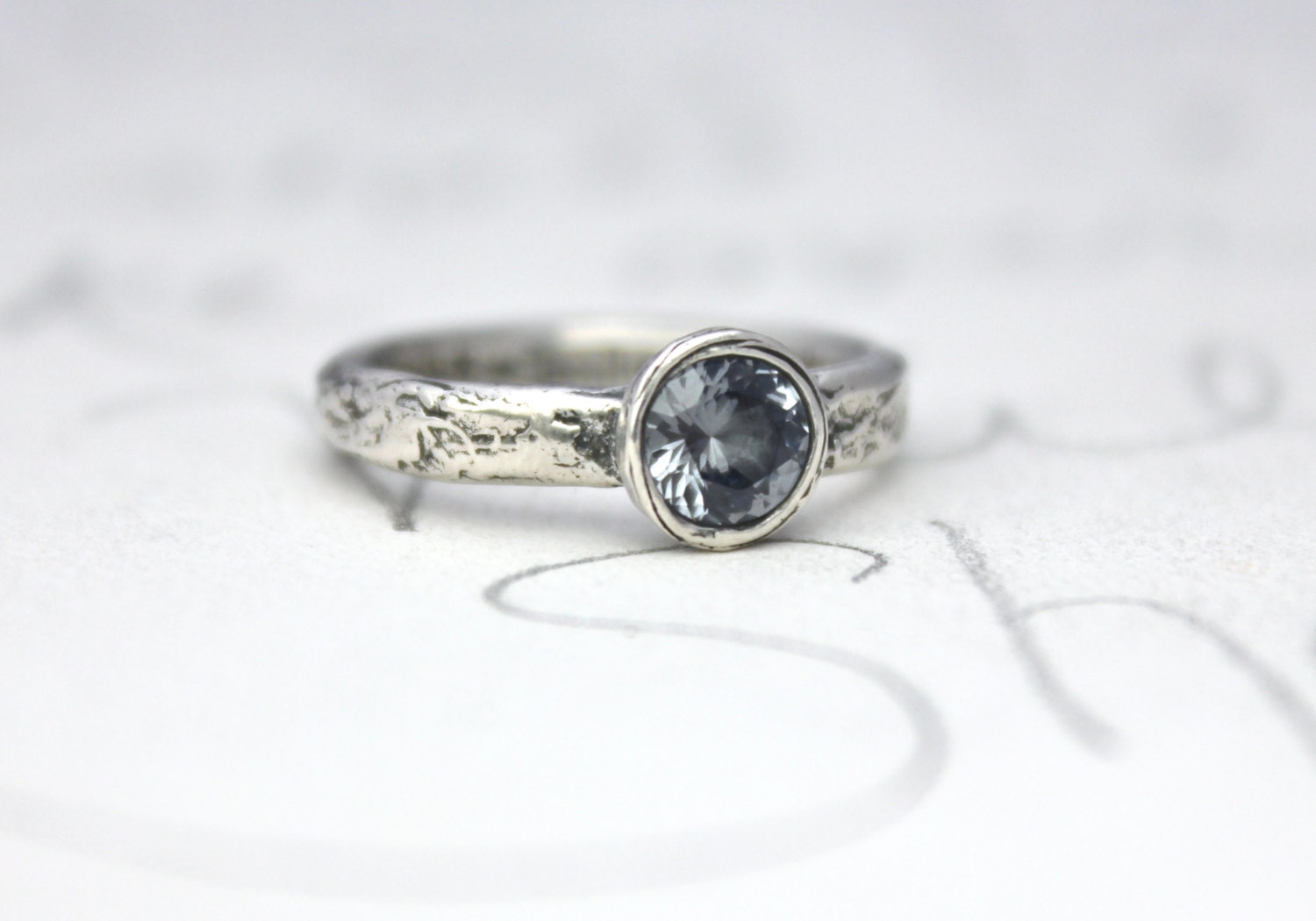blue grey spinel engagement ring . unique alternative river rock engagement ring . made to order by peaces of indigo