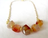 White variegated with orange aventurine necklace with gold plated chain. Cloudy transparent glossy semiprecious stone. Short length