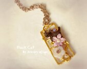 Black Cat necklace made with shell cat, glass flower, vintage flower, swarovski crystals etc.