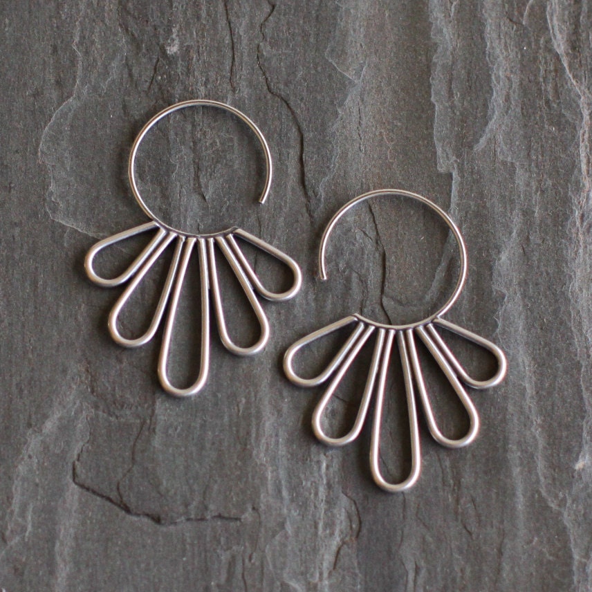 Elegant silver earrings with feather shapes soldered together to a hoop to make a modern piece of jewelry - "Peacock Hoop Earrings"