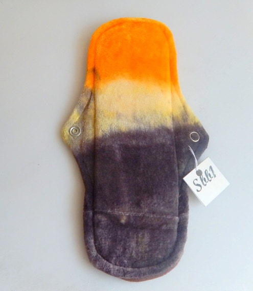1 Organic Reusable Cloth Menstrual Pad in a Hand Dyed Sunset Scene