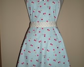 Vintage inspired 50s style Full apron strawberry print contrasting black cream polka dot straps with bows on bib and pocket